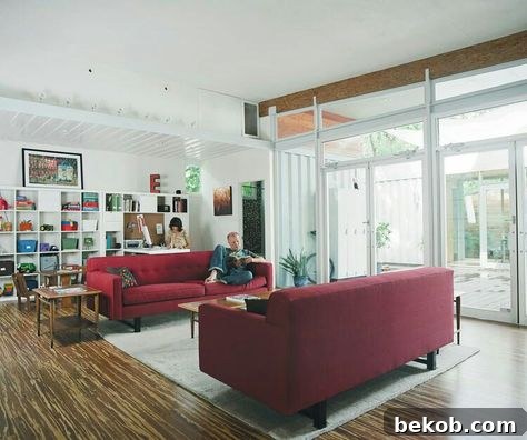 Decorating a neutral living room, with a maroon couch