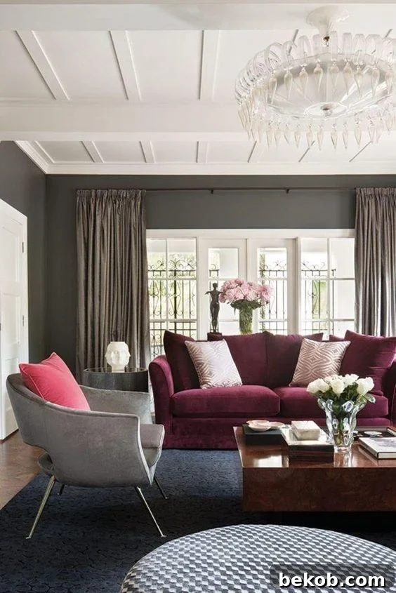 Decorating a neutral living room, with a maroon couch